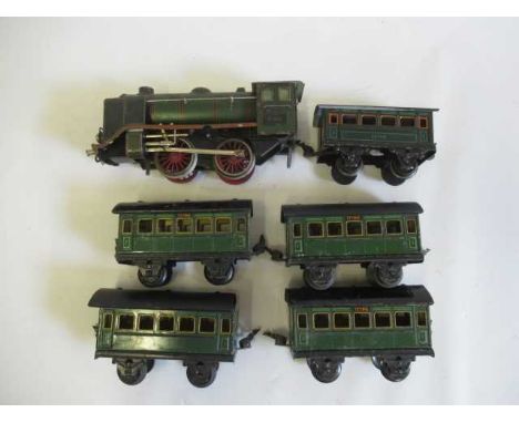 Marklin clockwork 0-4-0 locomotive finished in green R920 to cab, tender missing, with five coaches, some items have paint da
