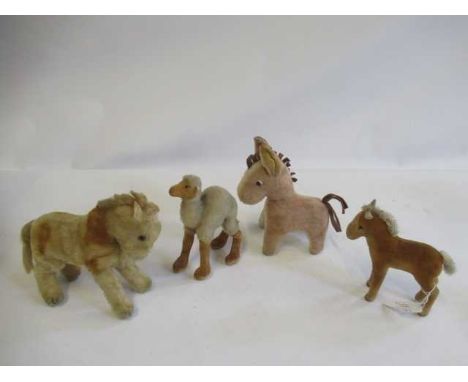 Four mid century Steiff items, comprising a Kamel, a Fohlen with silver button, a horse and a donkey (Est. plus 24% premium i
