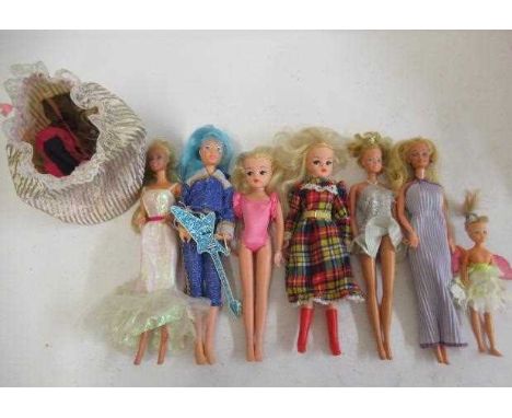 A collection of Barbie and Sindy dolls, including three barbies with Mattel 1966 marks, one glam rock example with Hasbro 198