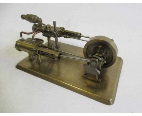 A twin cylinder horizontal steam engine of fabricated brass construction with reversing valve on brass base, a very well made