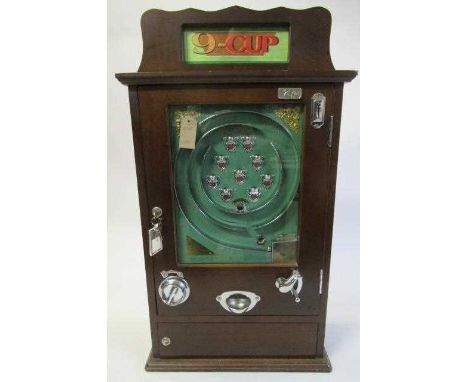 Modern Issue nine cup slot machine game, wooden case with chrome metal parts, E (Est. plus 24% premium inc. VAT)