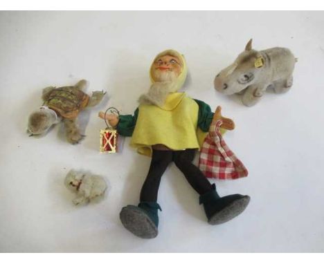 Three Steiff items, comprising a 27cm Happy Dwarf, a 14cm Slo with silver button, and a rhino with brass button and label, to