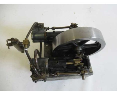 Stuart Turner H10 non-reversing twin cylinder horizontal steam engine mounted on wooden base with large fly wheel in centre o