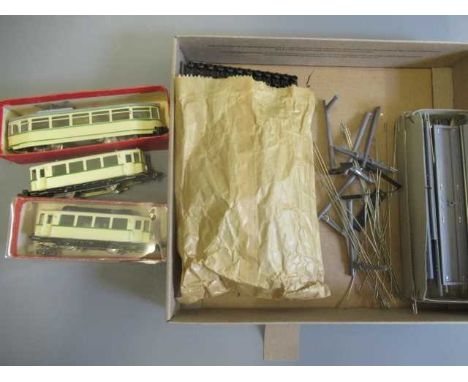 Two HAMO tram models finished in cream, one two and another bogie, a small quantity of track and pantograph poles, G (Est. pl