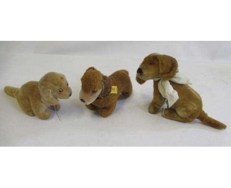 Three Steiff dogs, comprising a 1950s/60s Bazi, a later Bazi with silver button and a 1970s/80s Hexie Dackel with brass butto
