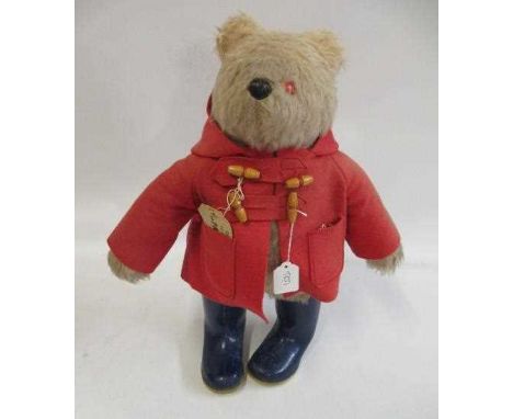 Paddington bear, with red felt coat, label and blue dunlop boots (Est. plus 24% premium inc. VAT)Condition Report: Could do w