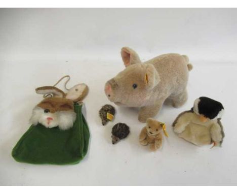 A collection of Steiff items, comprising a 10" Jolanthe pig, a rabbit bag, a penguin, two miniature hedgehogs, a bear and a s