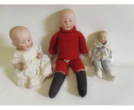 Three bisque head solemn boy dolls, one 9" possible Heubach shoulder head, with painted and moulded features, fabric body and