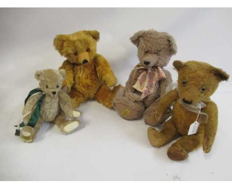 Four teddy bears, comprising a vintage straw filled teddy with clear glass eyes, orange plush and canvas pads, two 16 1/2" Me