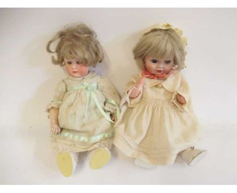 Two Heubach socket head dolls, one 11 1/2" 6970 doll with sleeping eyes, closed mouth and fixed wrists, and a 12" 10557 with 