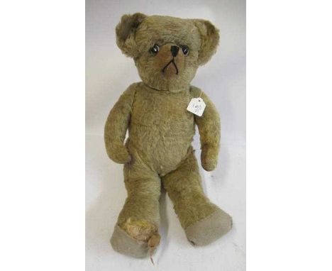 A mid-war English teddy bear, with glass clear eyes, sewn nose, orange plush and cloth paw pads, 19 1/2" long (Est. plus 24% 