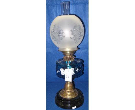 Early 20th Century brass double burner oil lamp with painted glass reservoirs, brass pedestal with ceramic base.  Frosted gla
