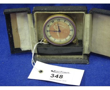 Cased Swiss made, gilt metal and enamel travel clock in original leather case, the face depicting tennis player.