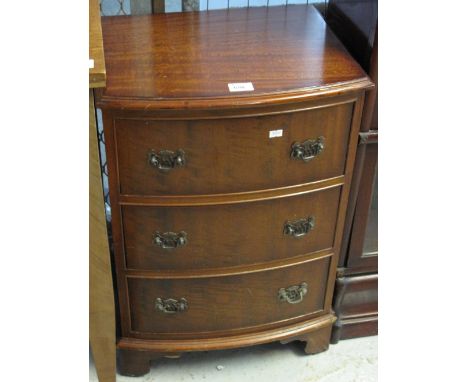 Small reproduction mahogany bow front narrow chest of three drawers on bracket feet,