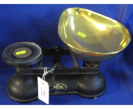 Pair of Salter cast metal and brass kitchen scales with weights.