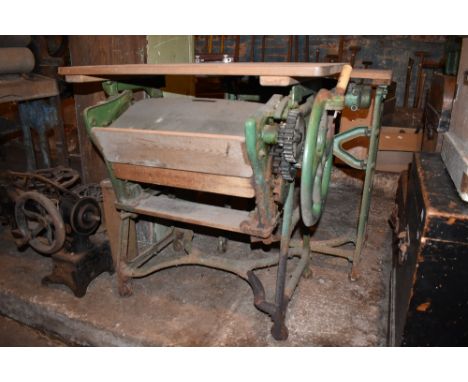 A cast iron and pine mangle, height 82cm, width 76cm, depth 50cm, and a smaller mangle table, the base cast with the name for