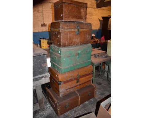 A steam bound wood and canvas travelling trunk, length 90cm, and four painted metal trunks (5).PROVENANCE: The Raymond Rush C