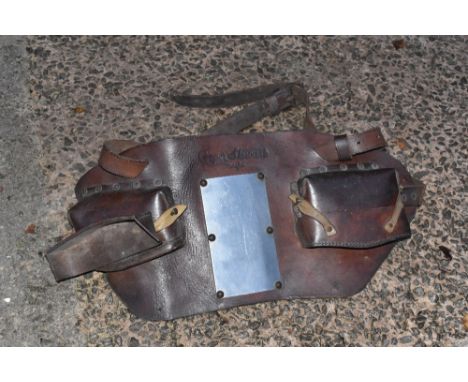 A tan leather vintage bull harness, with a metal bull harness and one other (3).PROVENANCE: The Raymond Rush Collection. Mr R