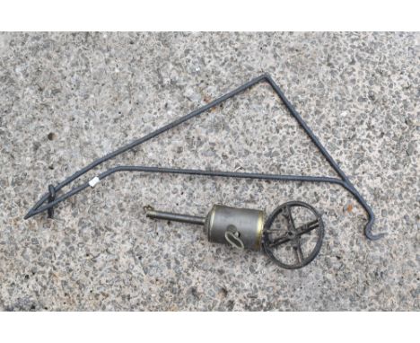 A vintage brass and iron country house spit jack with wrought iron bracket, the bracket length 71cm.PROVENANCE: The Raymond R
