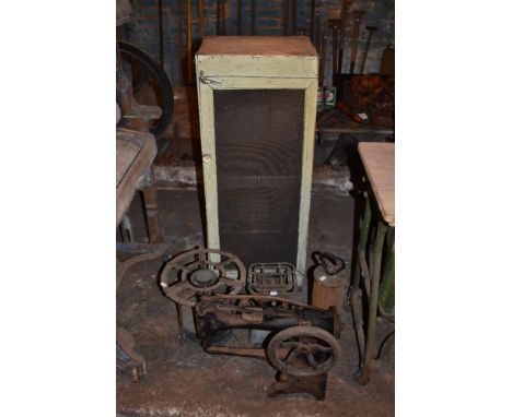 A vintage sewing machine, two stoves, a green painted pine food cupboard, and a cylindrical canister (5). PROVENANCE: The Ray
