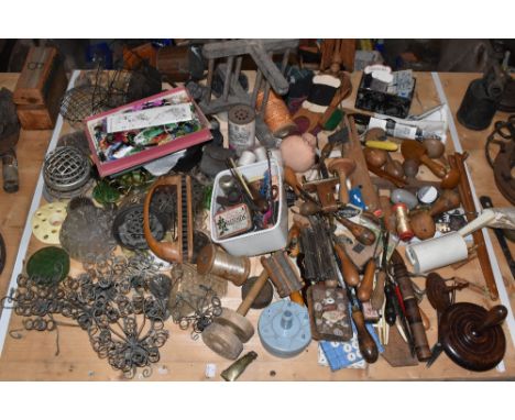 An assortment of vintage treen and other sewing related items, including winders, scissors, tools, etc.PROVENANCE: The Raymon