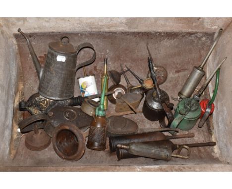 An assortment of vintage oil cans and grease guns, a selection of hand drills, hand tools and various metalware items (quanti