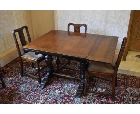 A 1930s oak draw-leaf dining table, with baluster legs on standard end supports, height 76cm, width when closed 91cm, depth 9