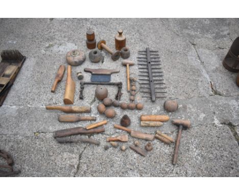 A selection of 19th century and later treen and metalware agricultural items, including various turned wooden weights, a two-