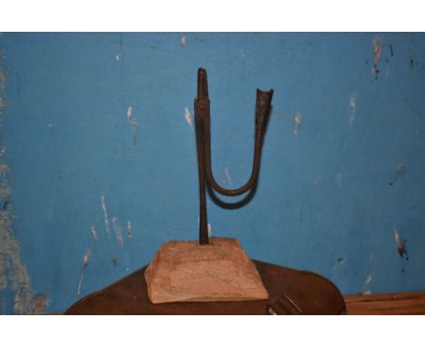 A 19th century wrought iron light, on naturalistic base, height 31cm.PROVENANCE: The Raymond Rush Collection. Mr Rush was an 