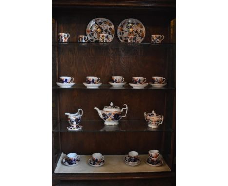 An early 19th century English china thirty-one piece Imari part tea and coffee service, comprising two plates, five coffee ca