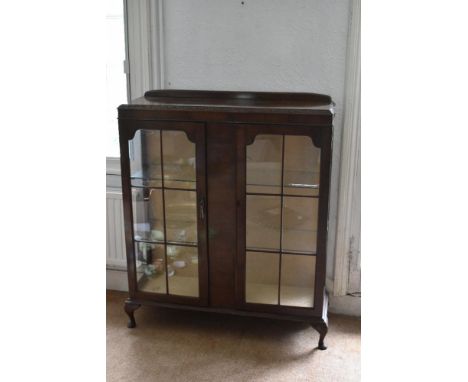 A 1930s walnut two door display cabinet, on cabriole legs, height 108cm, width 100cm, depth 33cm.PROVENANCE: The Raymond Rush