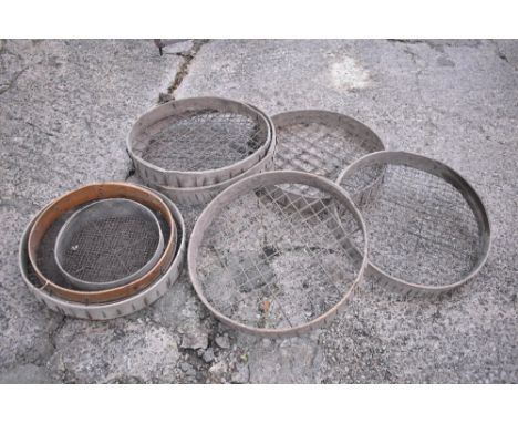 A collection of eight vintage ash and iron soil sieves, the largest diameter 60cm.PROVENANCE: The Raymond Rush Collection. Mr
