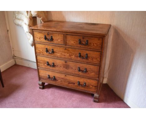 A late Victorian pitch pine chest of two short and three long drawers, on carved block feet, height 106cm, width 105cm, depth