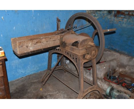 A vintage cast iron and pine slicing and threshing machine, 201cm.PROVENANCE: The Raymond Rush Collection. Mr Rush was an eng