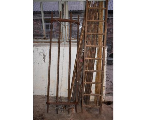 A vintage pine ladder, height 240cm, also a pitch pine hanging maid and a selection of garden canes (3).PROVENANCE: The Raymo