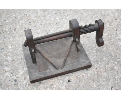 A vintage oak apothecary roller, with crank arm and V-shaped tray, on rectangular base, length 42cm.PROVENANCE: The Raymond R