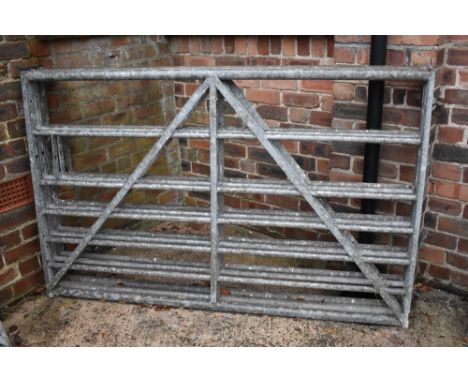Three five bar farm gates, height 114cm, width 180cm (3).PROVENANCE: The Raymond Rush Collection. Mr Rush was an engineer, fa