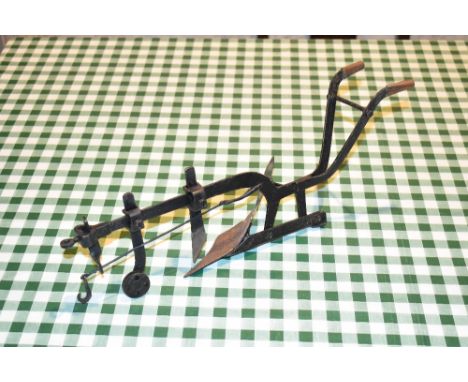 A contemporary iron model of a plough, length 40cm.PROVENANCE: The Raymond Rush Collection. Mr Rush was an engineer, farmer a