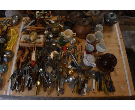 KITCHENALIA; a large collection of household kitchen items including tea infusers and strainers, copper kettles and an assort