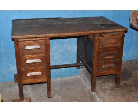 A 1930s oak office desk, with two shelves and six drawers on square legs, height 8cm, width 126cm, depth 73cm. This is the de