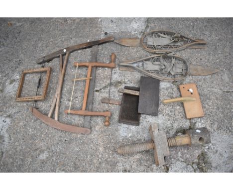 Two vintage carpenter's saws, the longest 80cm, also a pair of vintage snow shoes, length 76cm, a pine winding frame, three c