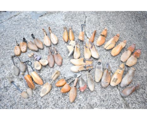 A large collection of treen and metal shoe moulds, lasts and mould sections, of varying design.PROVENANCE: The Raymond Rush C