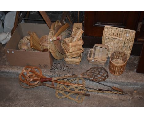 Two vintage metal carpet beaters with turned wooden handles, four wicker carpet beaters, a selection of wooden boxes and tray