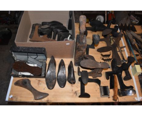 An assortment of vintage cobbler's iron lasts, the tallest 42cm, with related items. PROVENANCE: The Raymond Rush Collection.