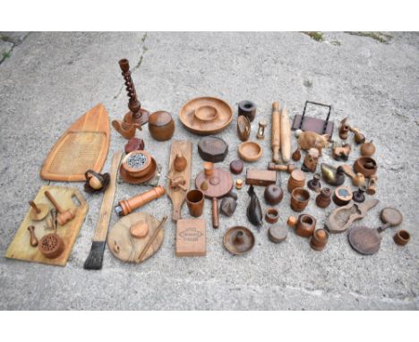 A large selection of mostly 20th century treen items including a candlestick, chamberstick, model mushroom, octagonal box and