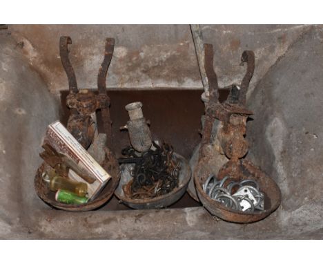 Four vintage iron Fordham type cow feeders, with a selection of chains and other items. PROVENANCE: The Raymond Rush Collecti