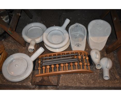 A collection of seven vintage bed pans, including a white enamel example with circular lid, diameter 46cm, and a New Slipper 