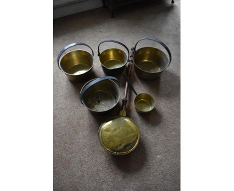Four brass and cast iron preserving pans, the largest diameter 32.5cm, also a smaller brass saucepan and a 19th century brass