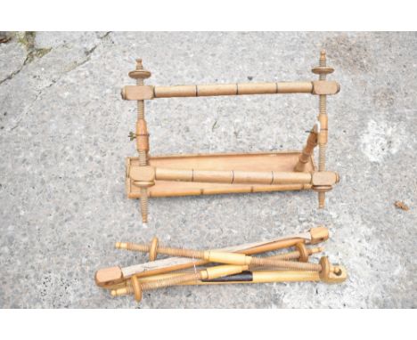 A beech tapestry rack, on rectangular base with bamboo shaped sides, height 37cm, also a four section beech tapestry frame (5