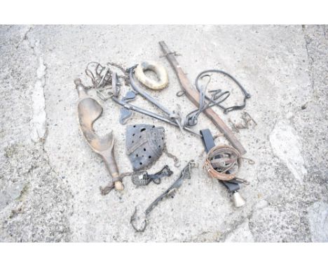 A vintage pine box yoke, a pair of stirrups, a leather muzzle, and other horse related items, with a tan lather animal collar